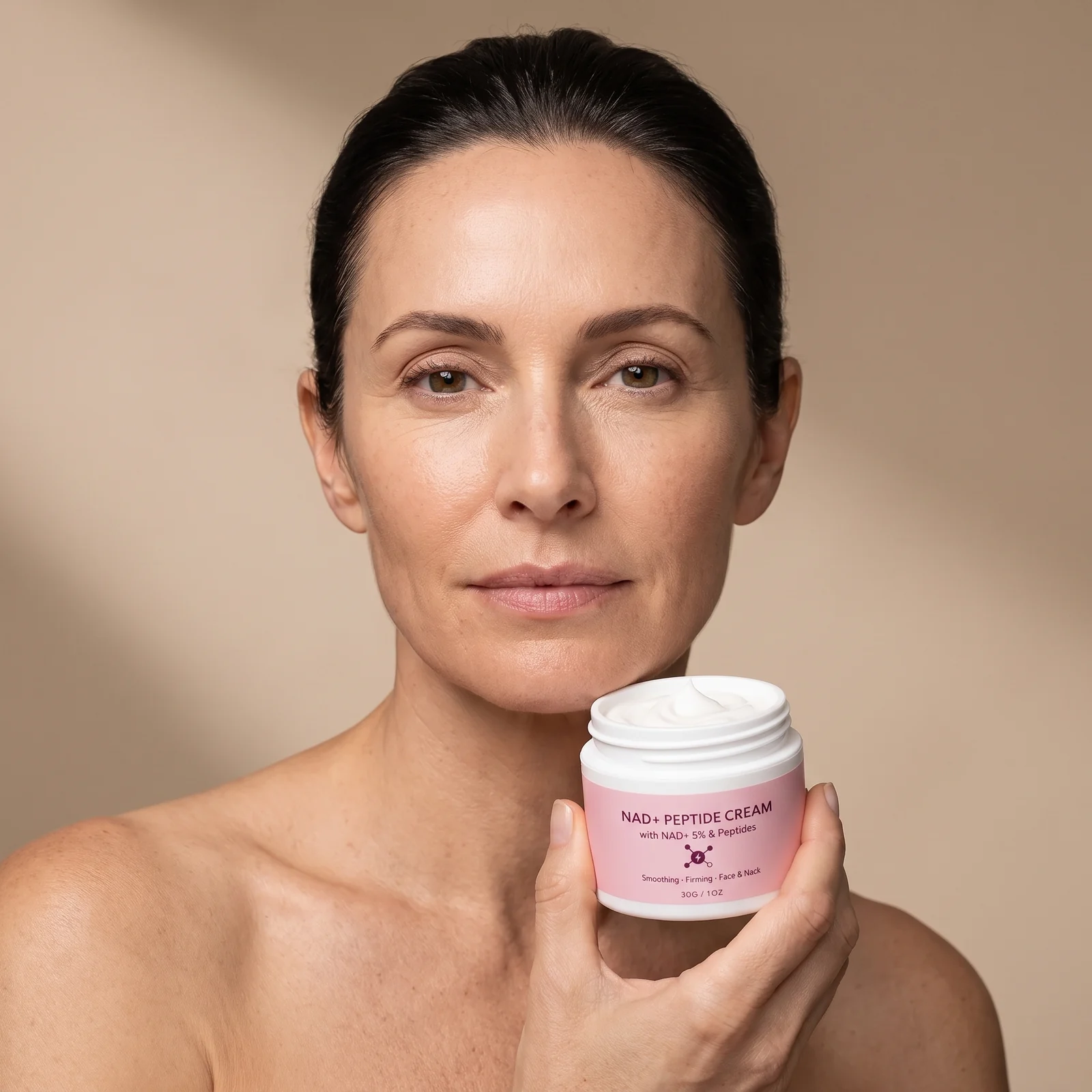 Woman in her late forties holding the open jar and touching her neck